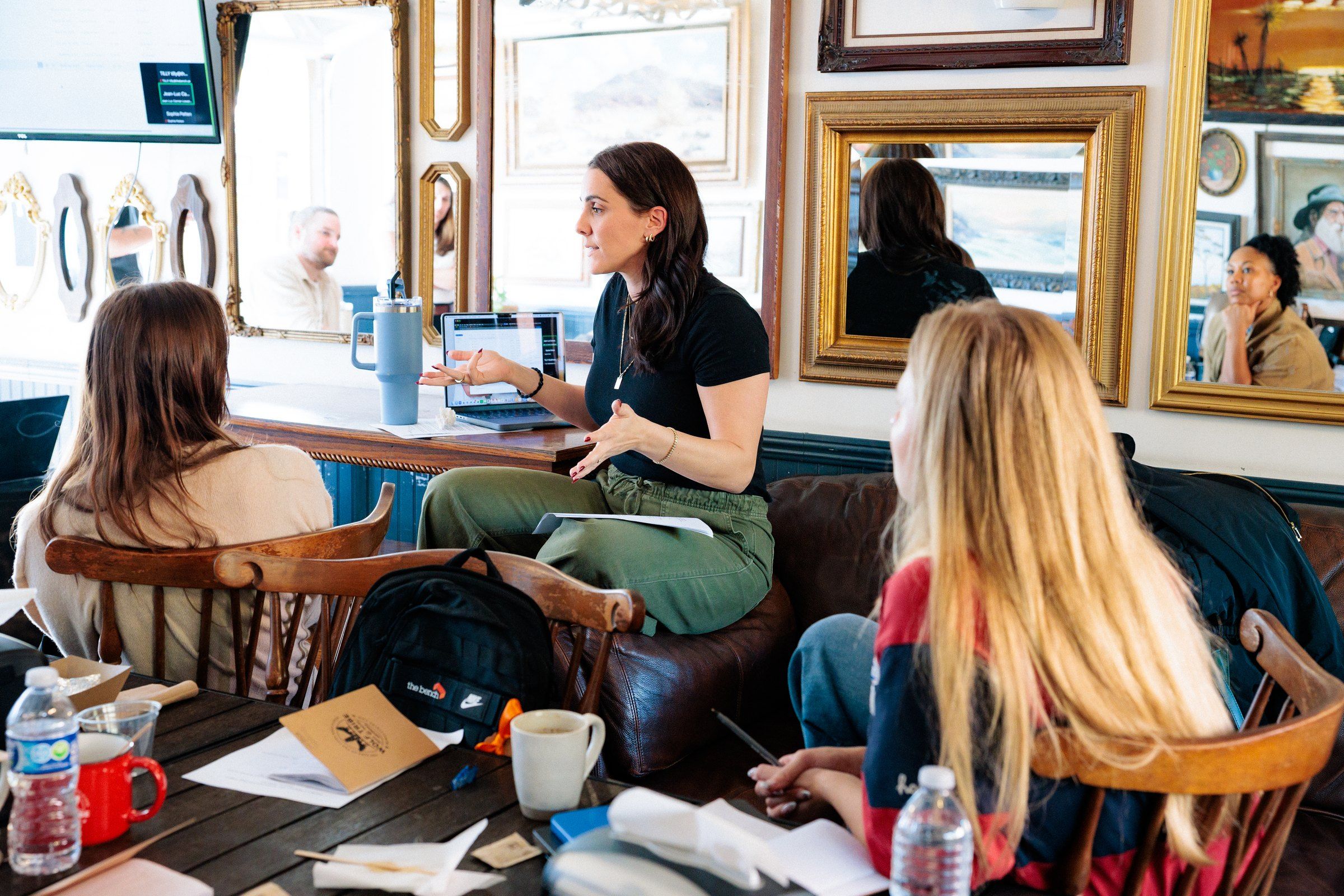 A member of The Bench core team leads a working session around a table.