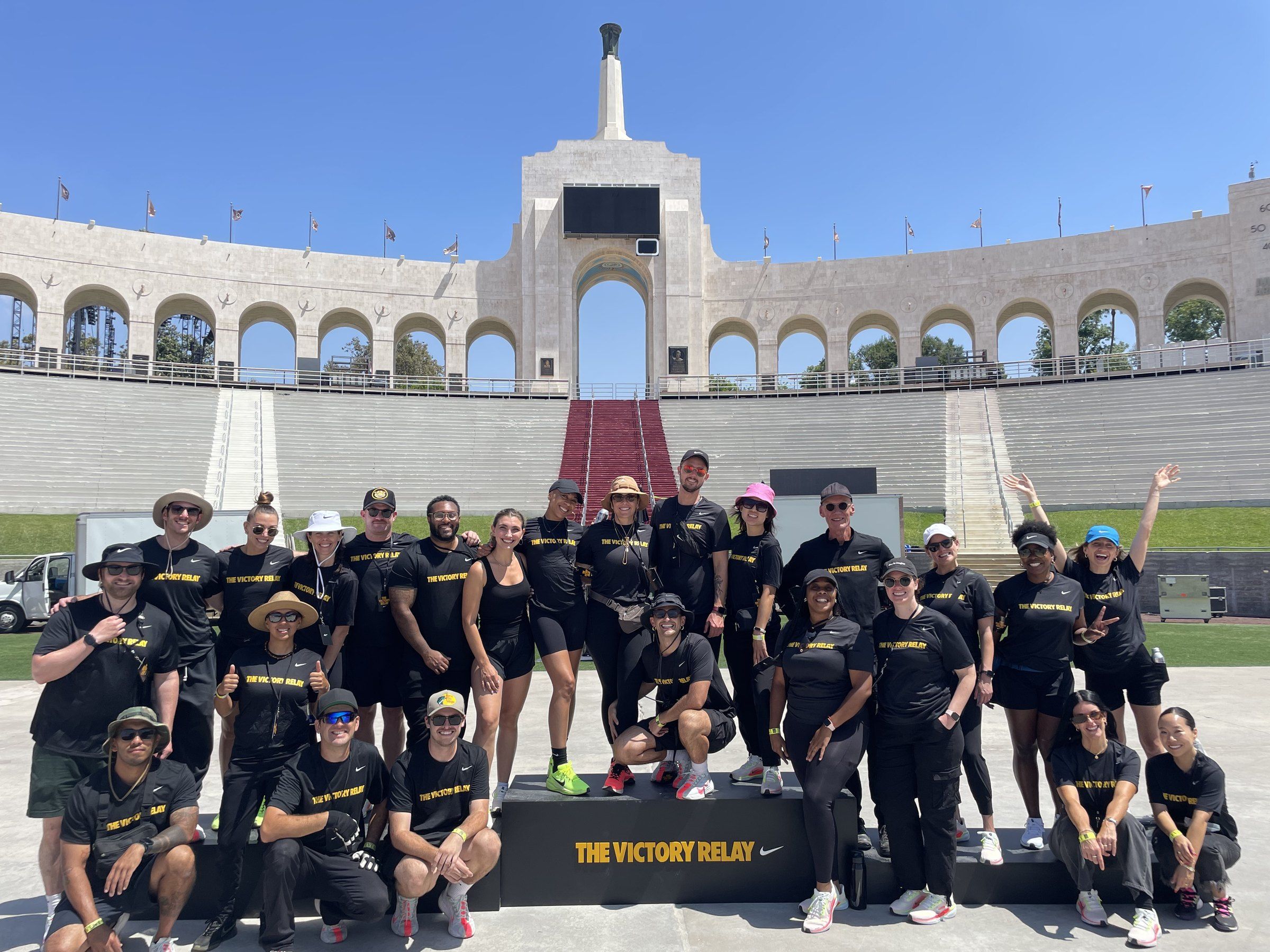 The Bench crew in Victory Relay shirts on the field at the LA Memorial Coliseum.